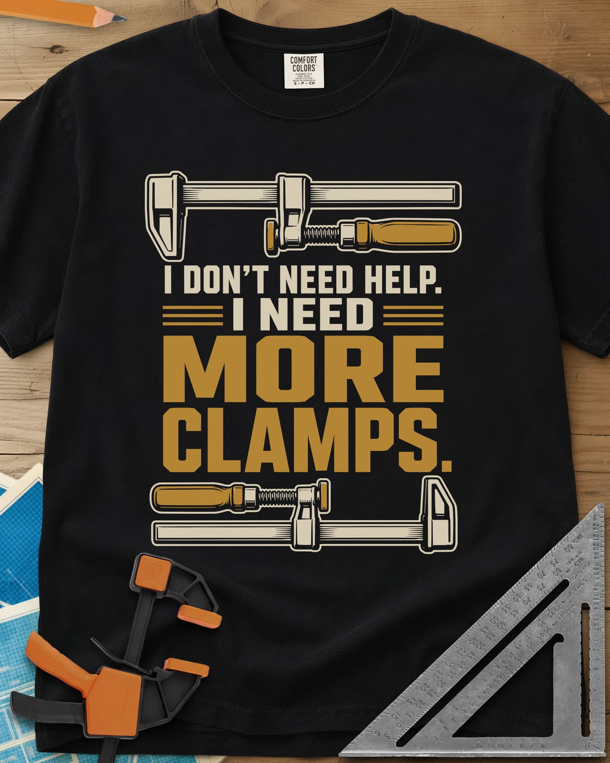 I Don't Need Help I Need More Clamps heavyweight tee in Black, two bar clamps above and below bold stacked lettering