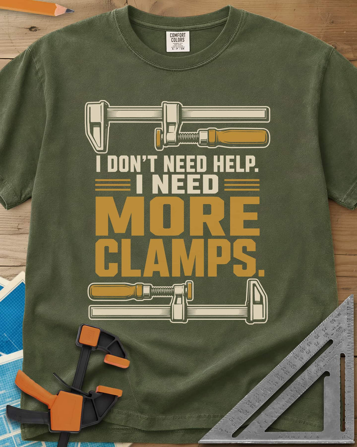 I Don't Need Help I Need More Clamps heavyweight tee in Hemp, two bar clamps above and below bold stacked lettering