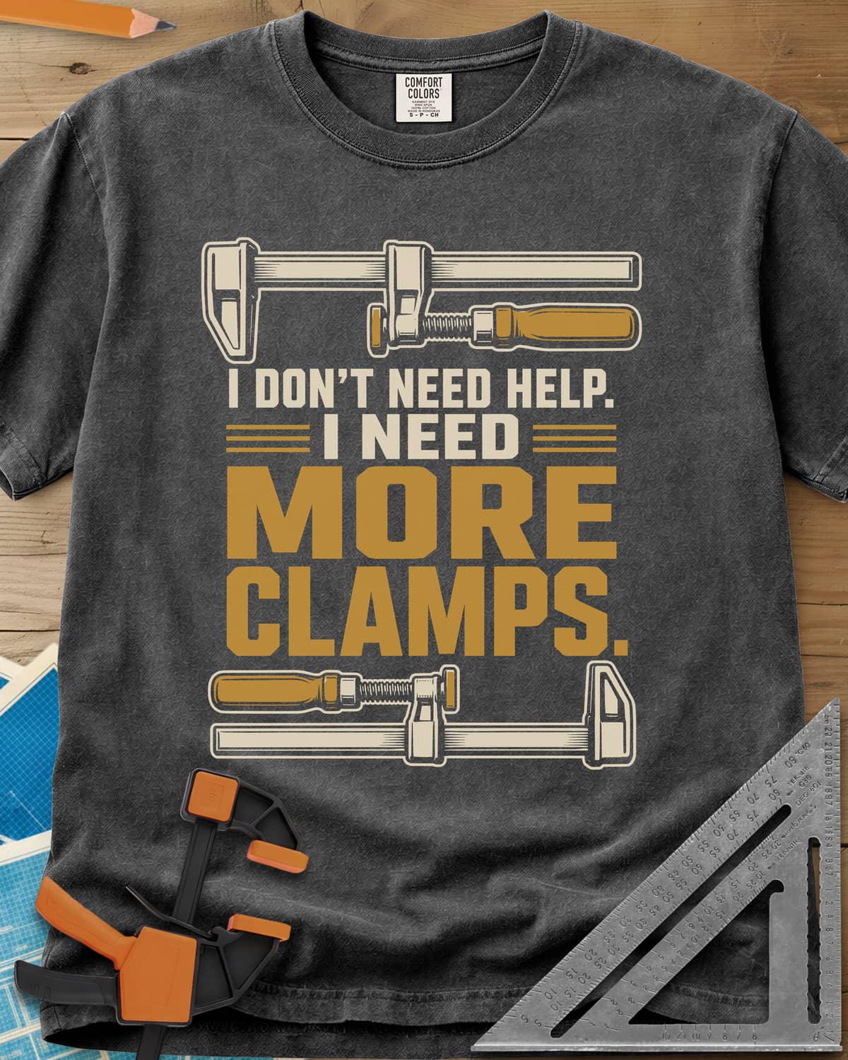 I Don't Need Help I Need More Clamps heavyweight tee in Pepper, two bar clamps above and below bold stacked lettering