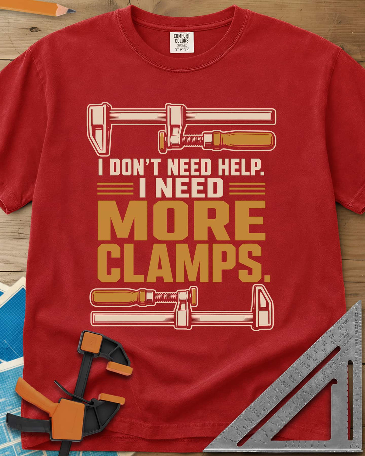 I Don't Need Help I Need More Clamps heavyweight tee in Red, two bar clamps above and below bold stacked lettering