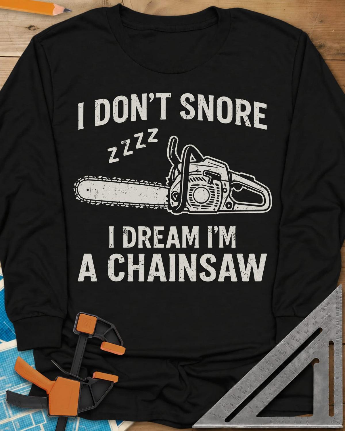 I Dream I'm A Chainsaw long sleeve shirt in Black, a chainsaw with zzzz above it between two lines of text