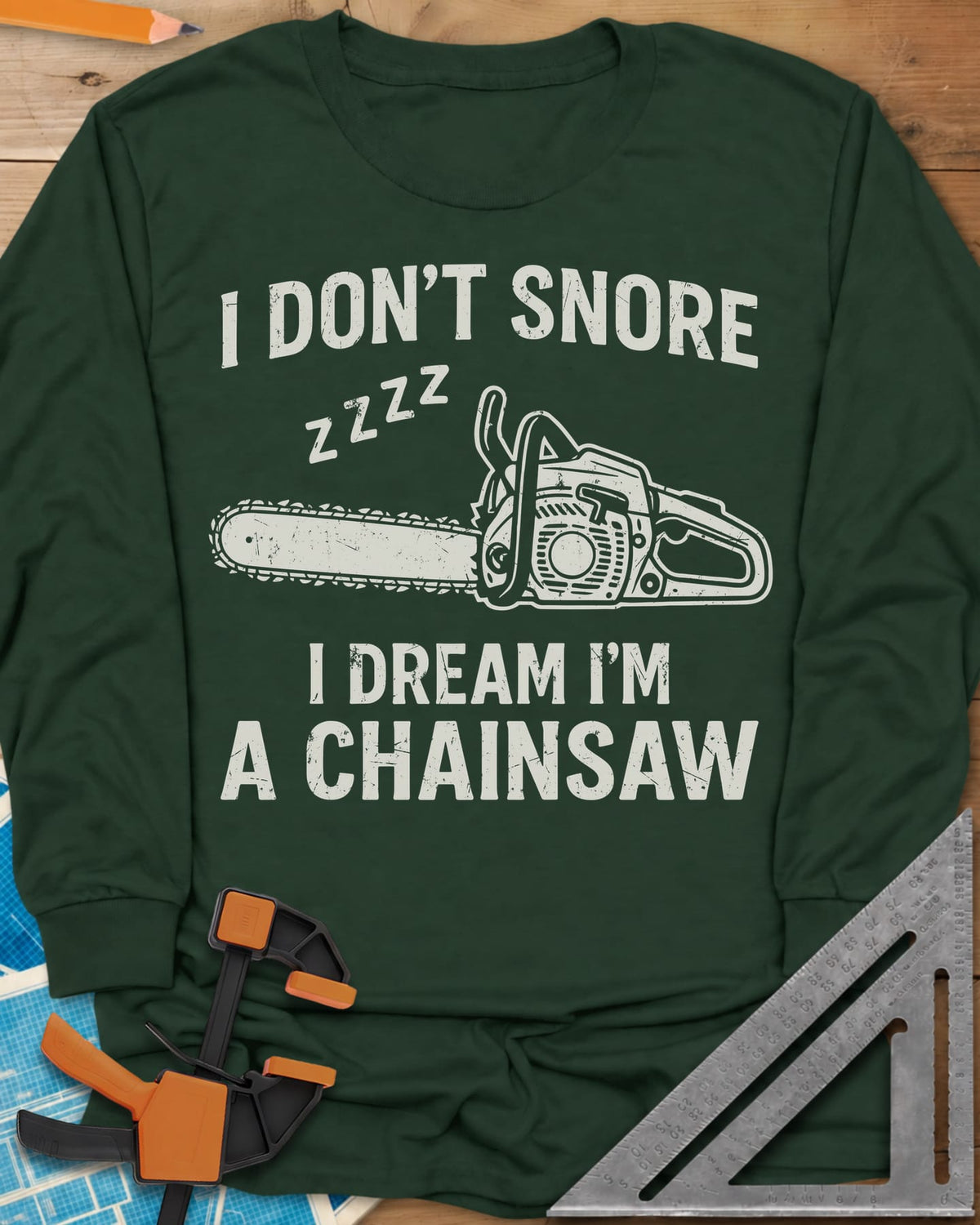 I Dream I'm A Chainsaw long sleeve shirt in Forest Green, a chainsaw with zzzz above it between two lines of text
