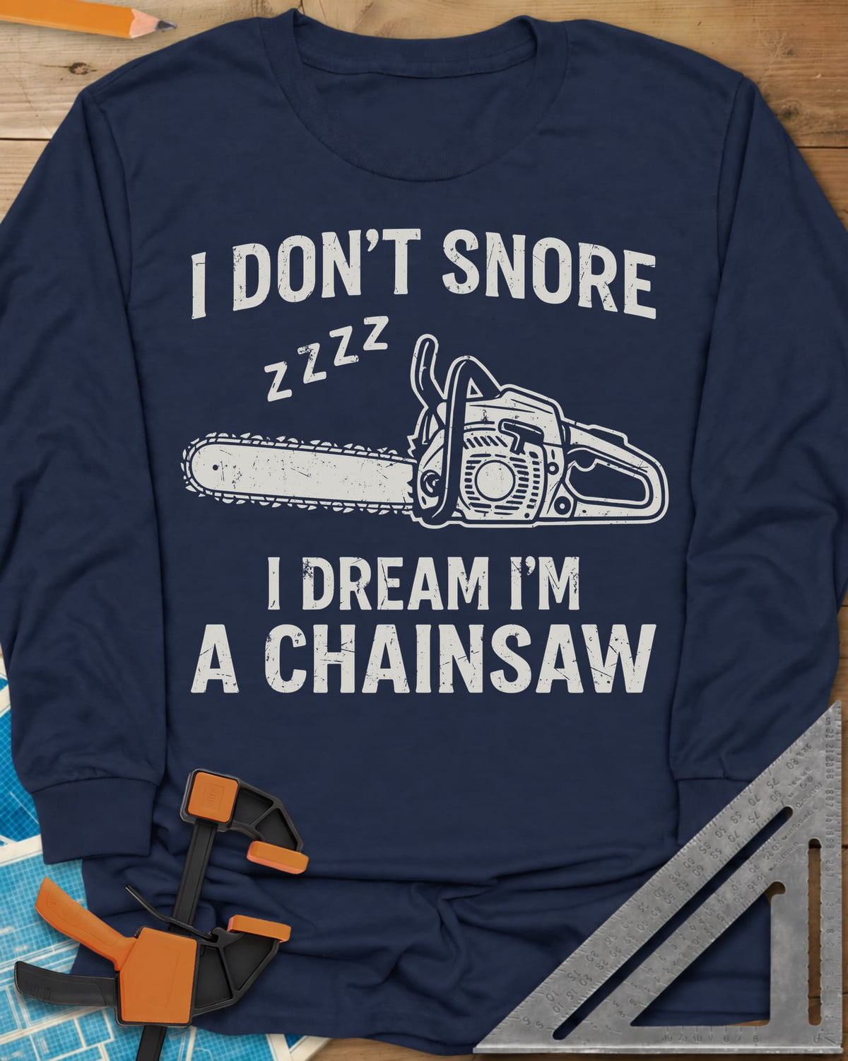 I Dream I'm A Chainsaw long sleeve shirt in Navy, a chainsaw with zzzz above it between two lines of text