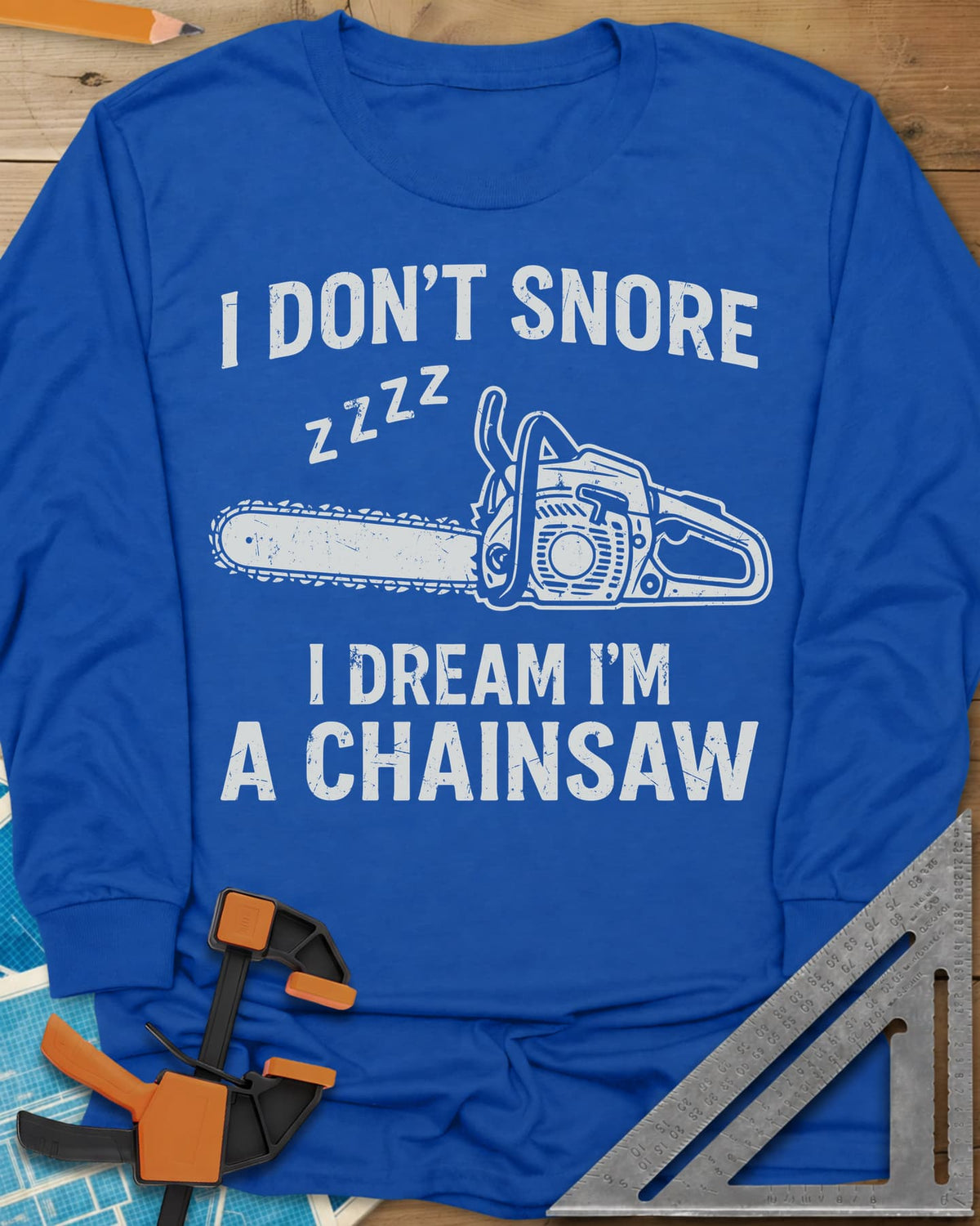 I Dream I'm A Chainsaw long sleeve shirt in Royal, a chainsaw with zzzz above it between two lines of text