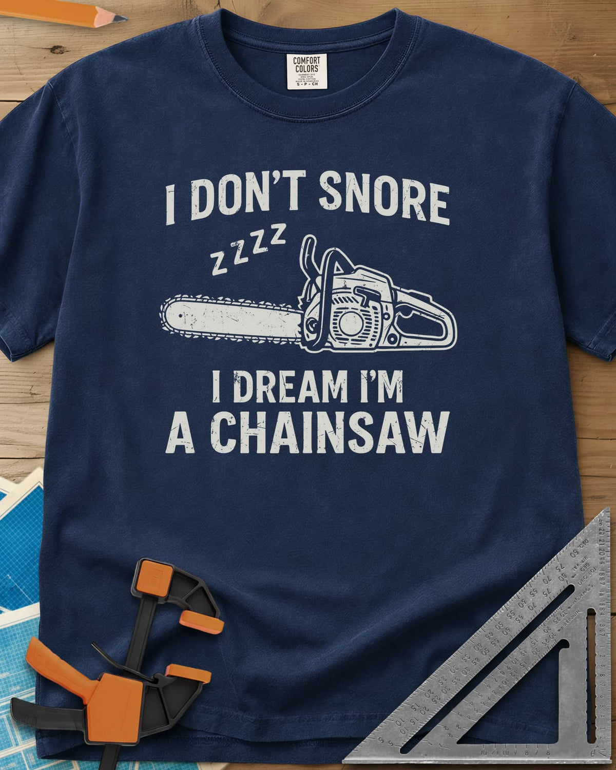 I Dream I'm A Chainsaw heavyweight tee in Navy, a chainsaw with zzzz above it between two lines of text