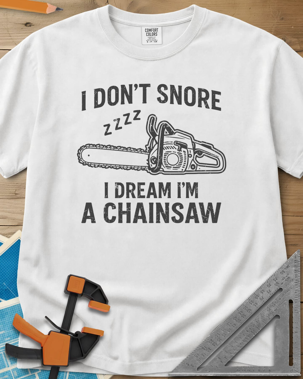 I Dream I'm A Chainsaw heavyweight tee in White, a chainsaw with zzzz above it between two lines of text
