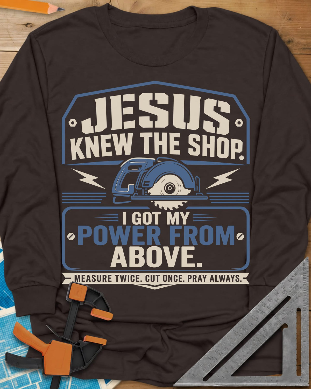 I Got My Power From Above long sleeve shirt in Dark Chocolate, a blue circular saw with lightning bolts in a badge
