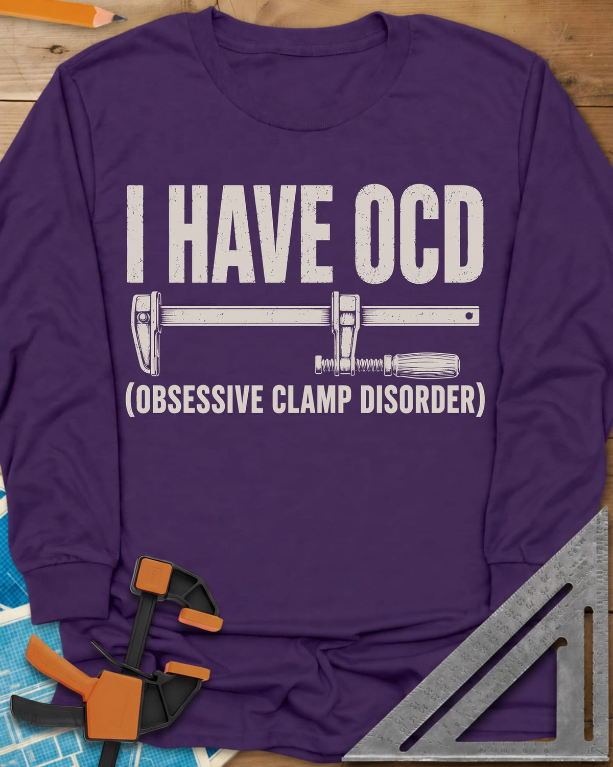 I Have OCD long sleeve shirt in Purple, long bar clamp drawn between the headline and its explanation