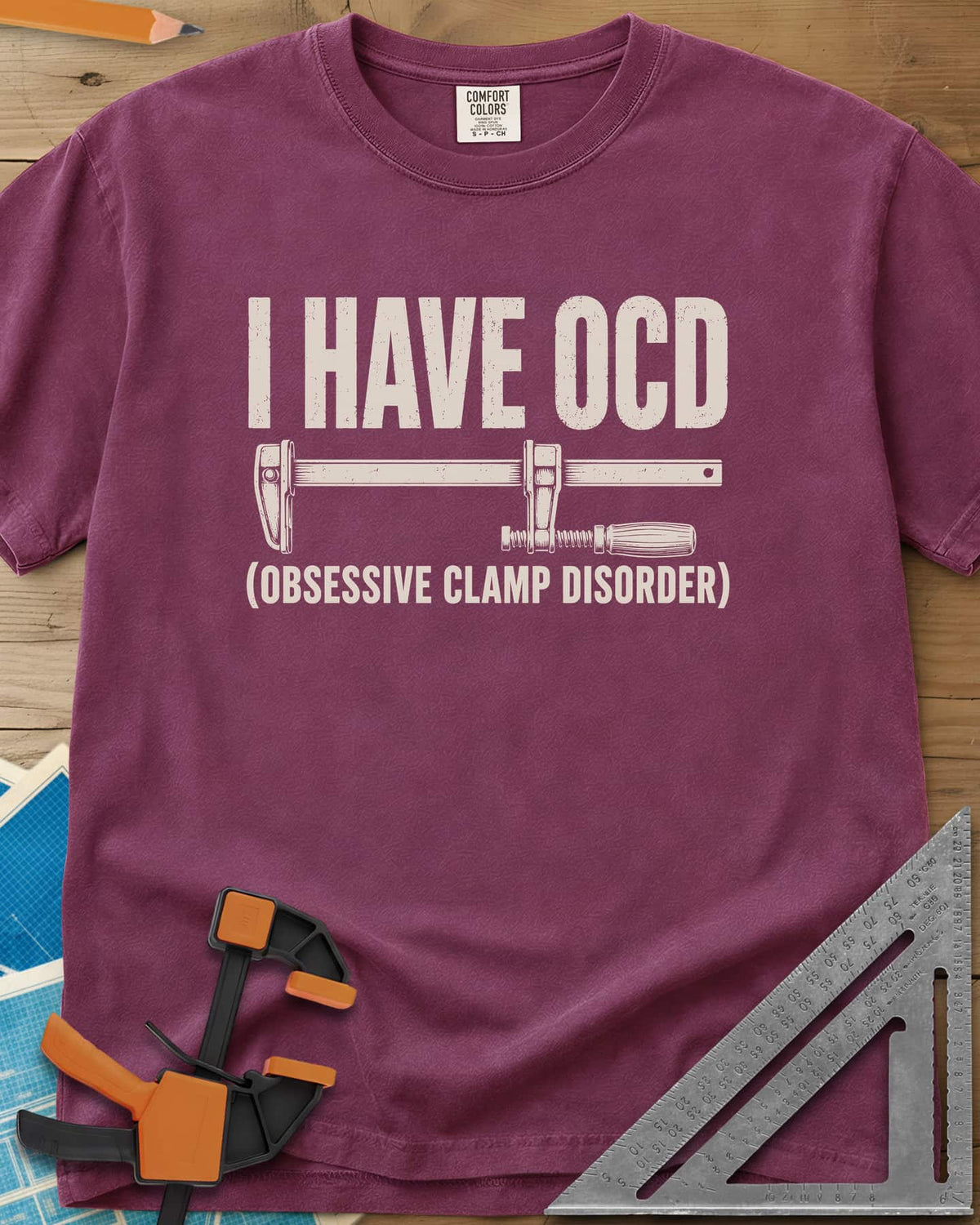 I Have OCD heavyweight tee in Berry, long bar clamp drawn between the headline and its explanation