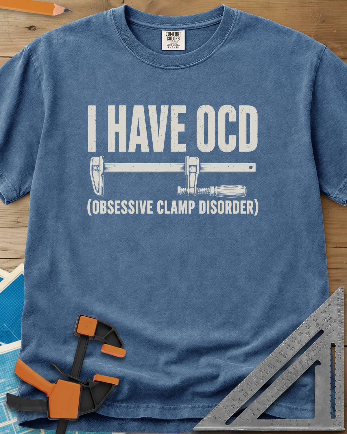 I Have OCD heavyweight tee in Blue Jean, long bar clamp drawn between the headline and its explanation