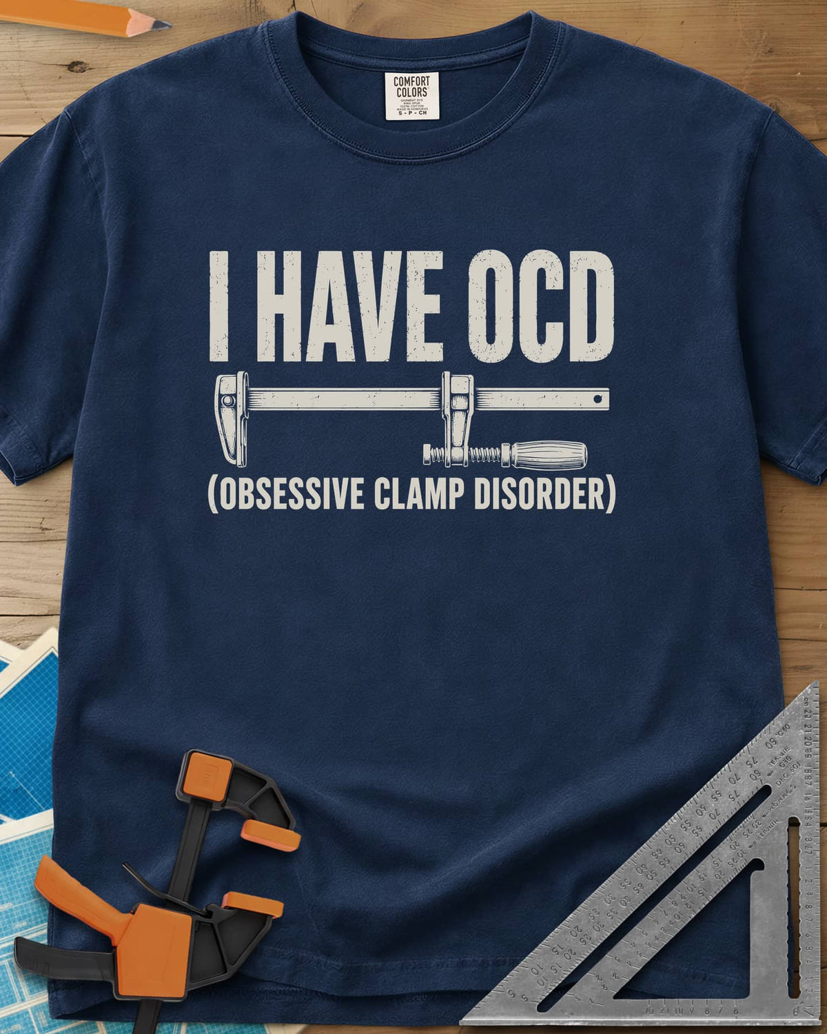 I Have OCD heavyweight tee in Navy, long bar clamp drawn between the headline and its explanation