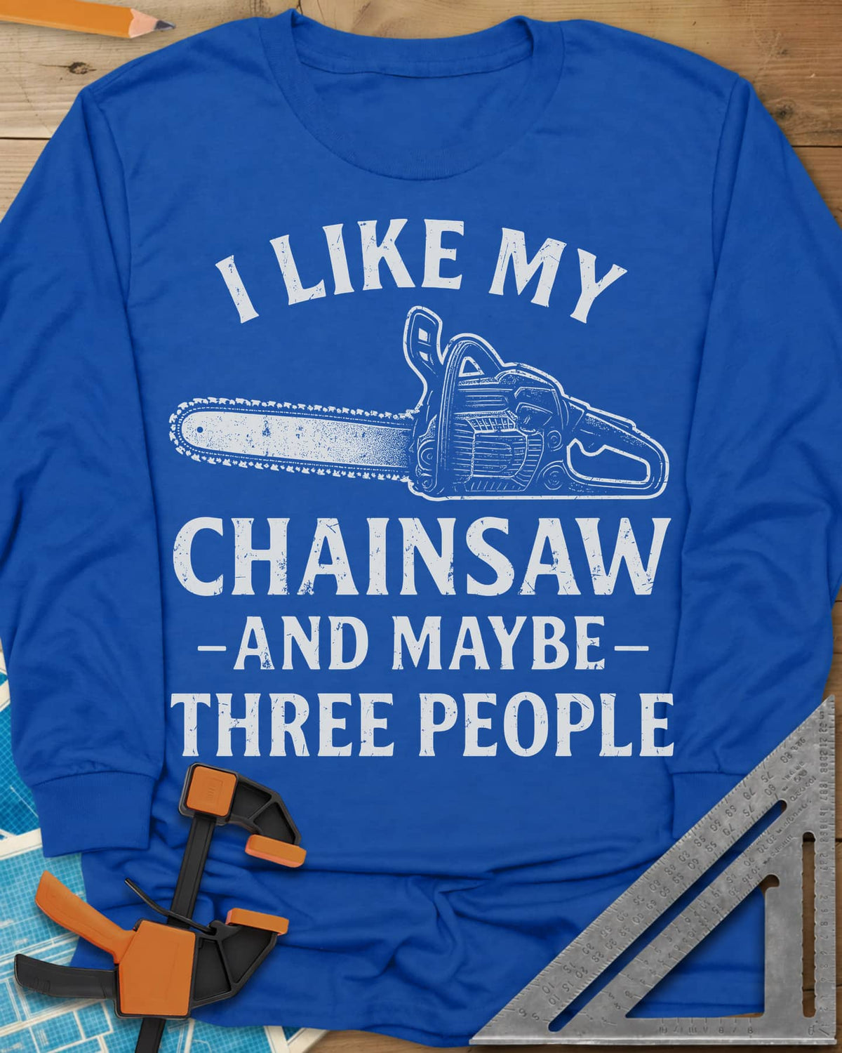 I Like My Chainsaw long sleeve shirt in Royal, distressed chainsaw drawing between the first and second lines