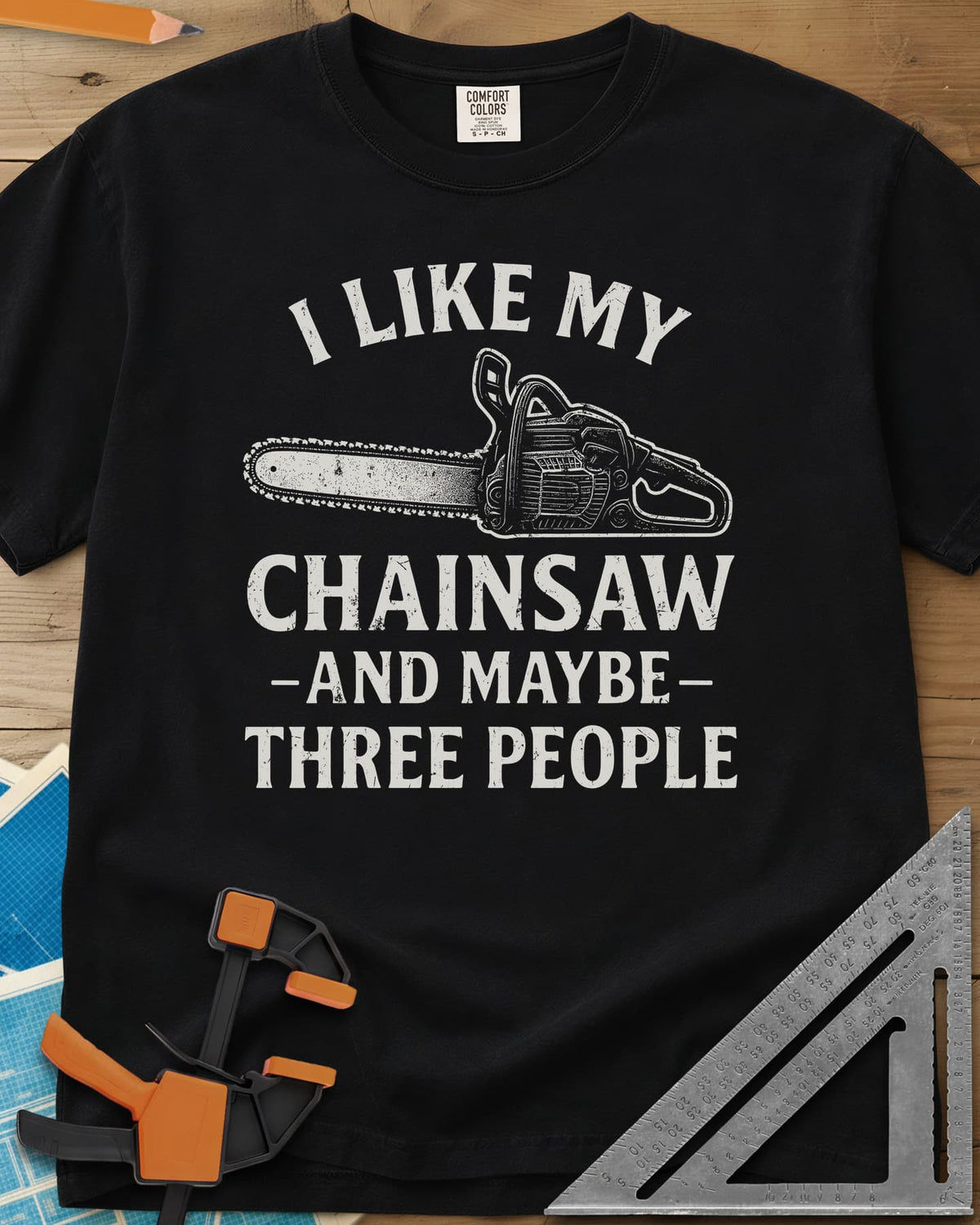 I Like My Chainsaw heavyweight tee in Black, distressed chainsaw drawing between the first and second lines