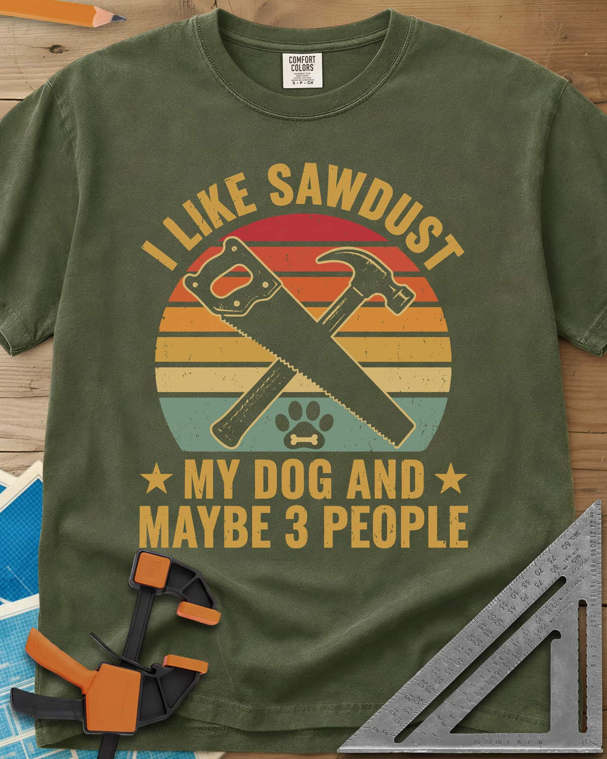 I Like Sawdust heavyweight tee in Hemp, a hand saw crossed with a hammer over a paw print on retro stripes