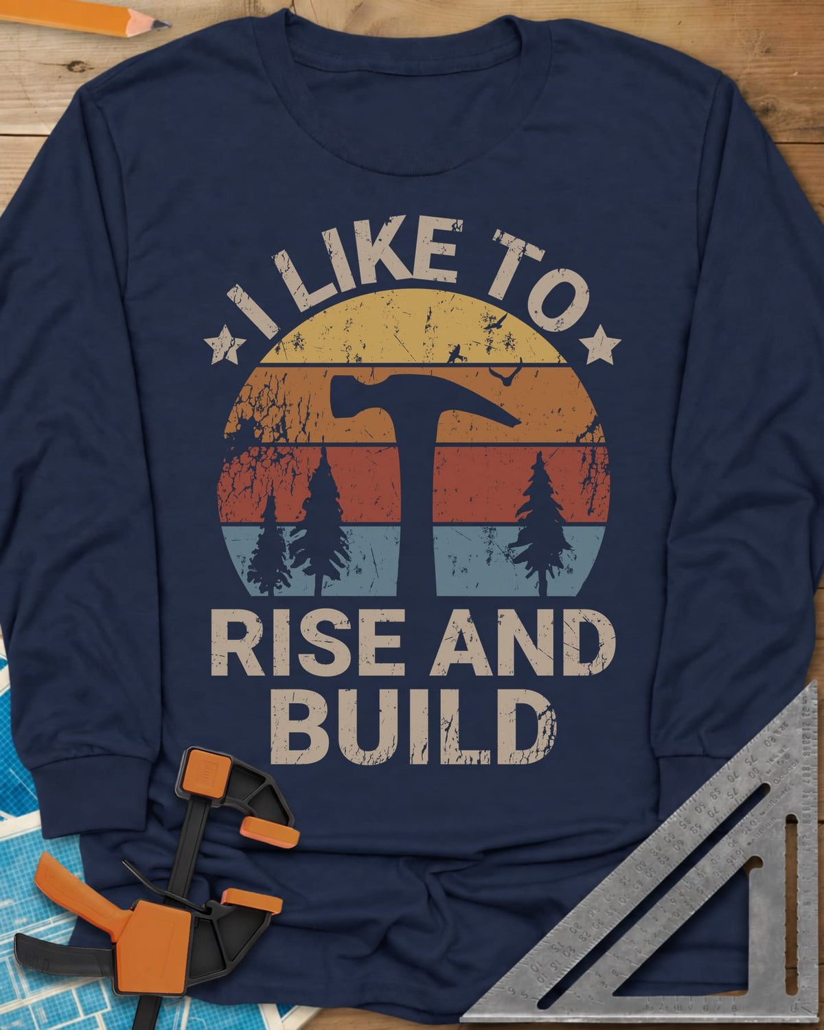 I Like To Rise And Build long sleeve shirt in Navy, a retro striped sunset with a hammer silhouette and pine trees