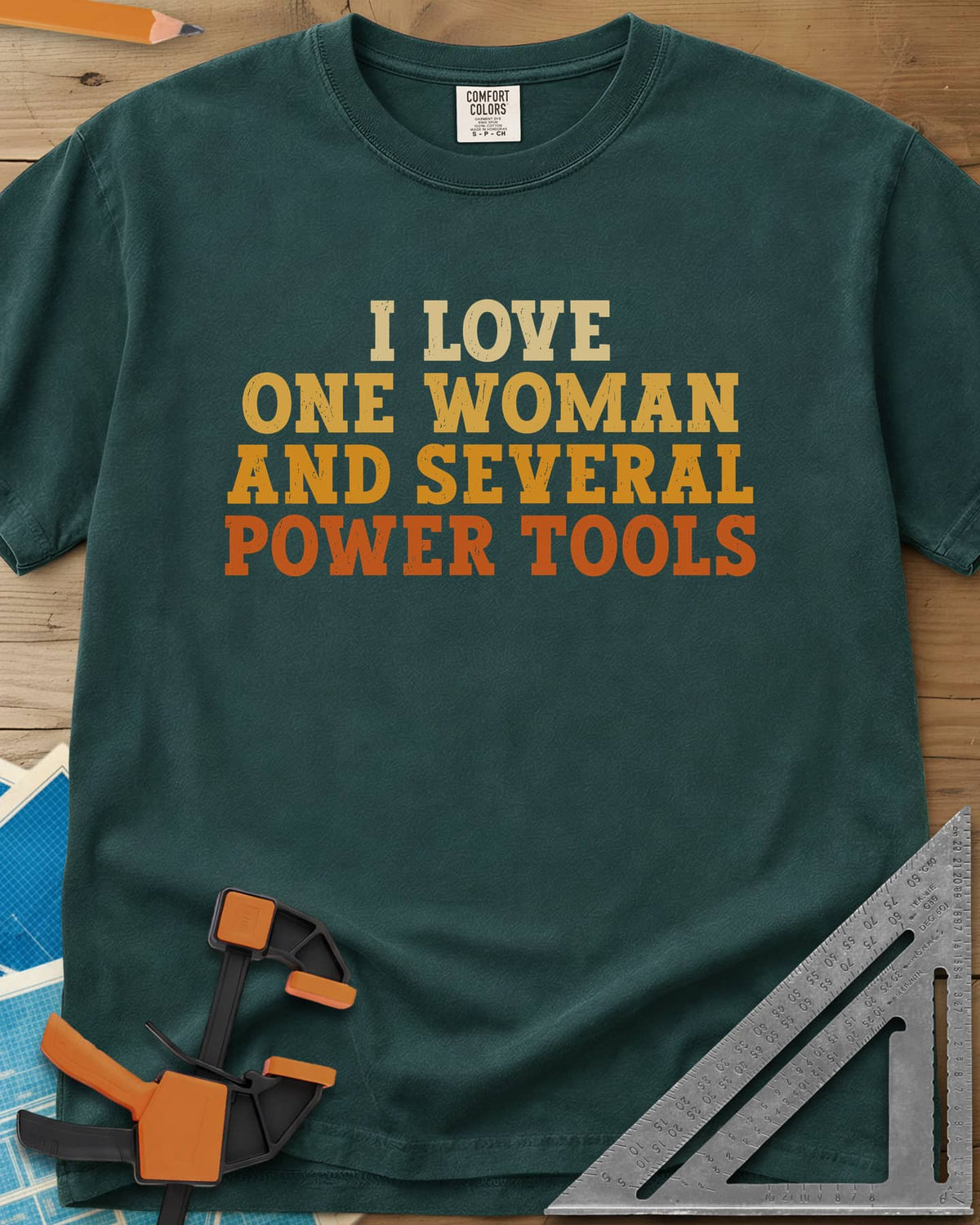 I Love One Woman And Several Power Tools heavyweight tee in Blue Spruce, four stacked lines of slab-serif type fading from