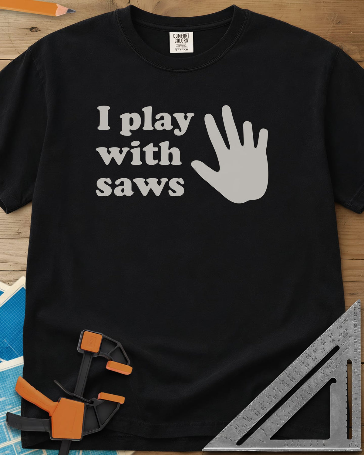 I Play With Saws heavyweight tee in Black, rounded lowercase lettering beside a big open hand, five fingers