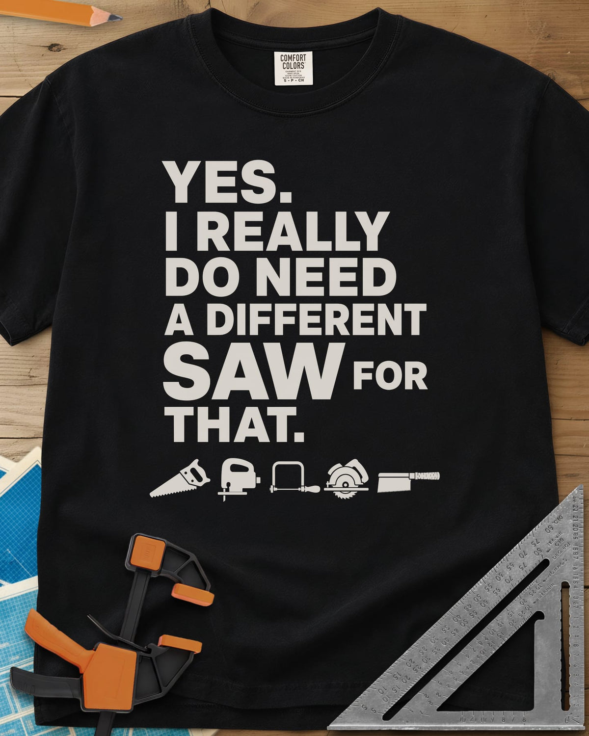 I Really Do Need A Different Saw heavyweight tee in Black, bold stacked lettering above a row of five small saw icons