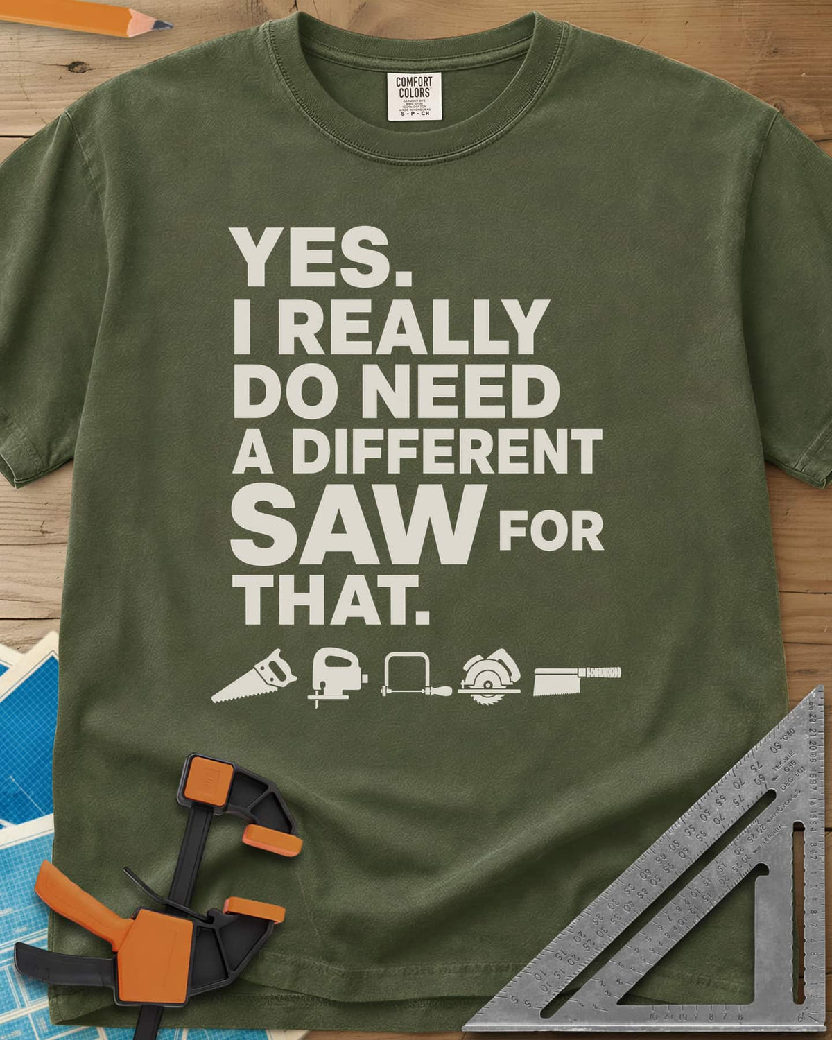 I Really Do Need A Different Saw heavyweight tee in Hemp, bold stacked lettering above a row of five small saw icons