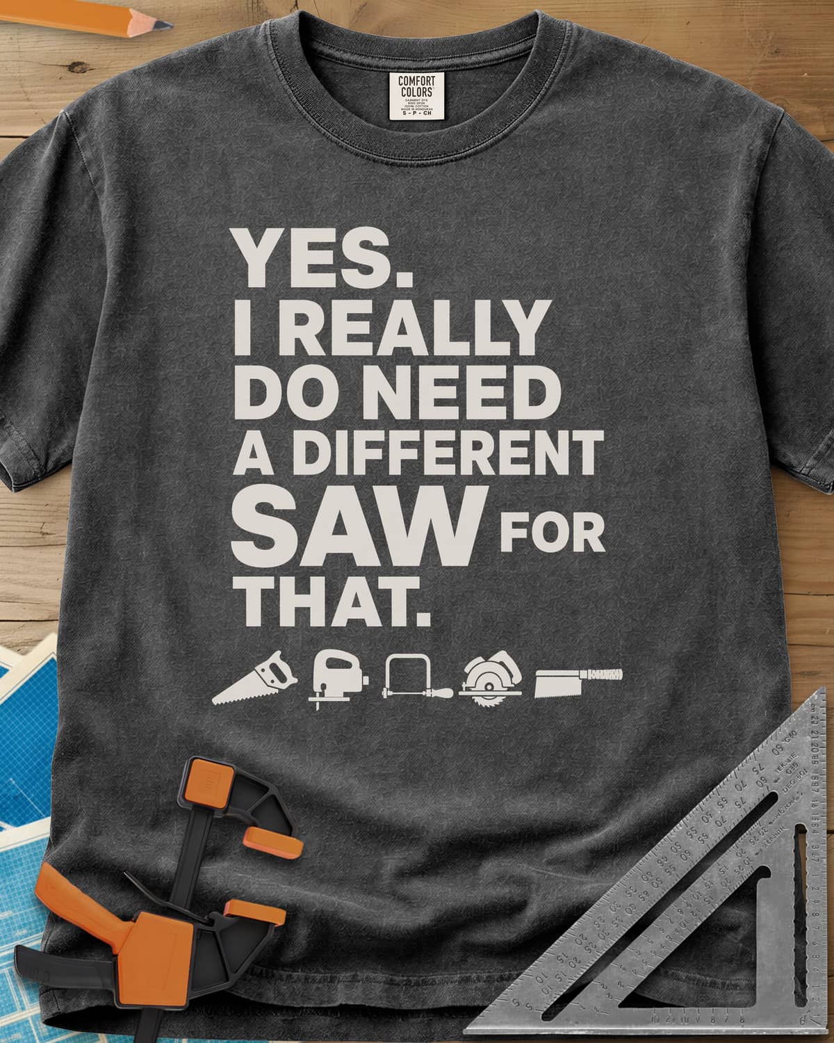 I Really Do Need A Different Saw heavyweight tee in Pepper, bold stacked lettering above a row of five small saw icons