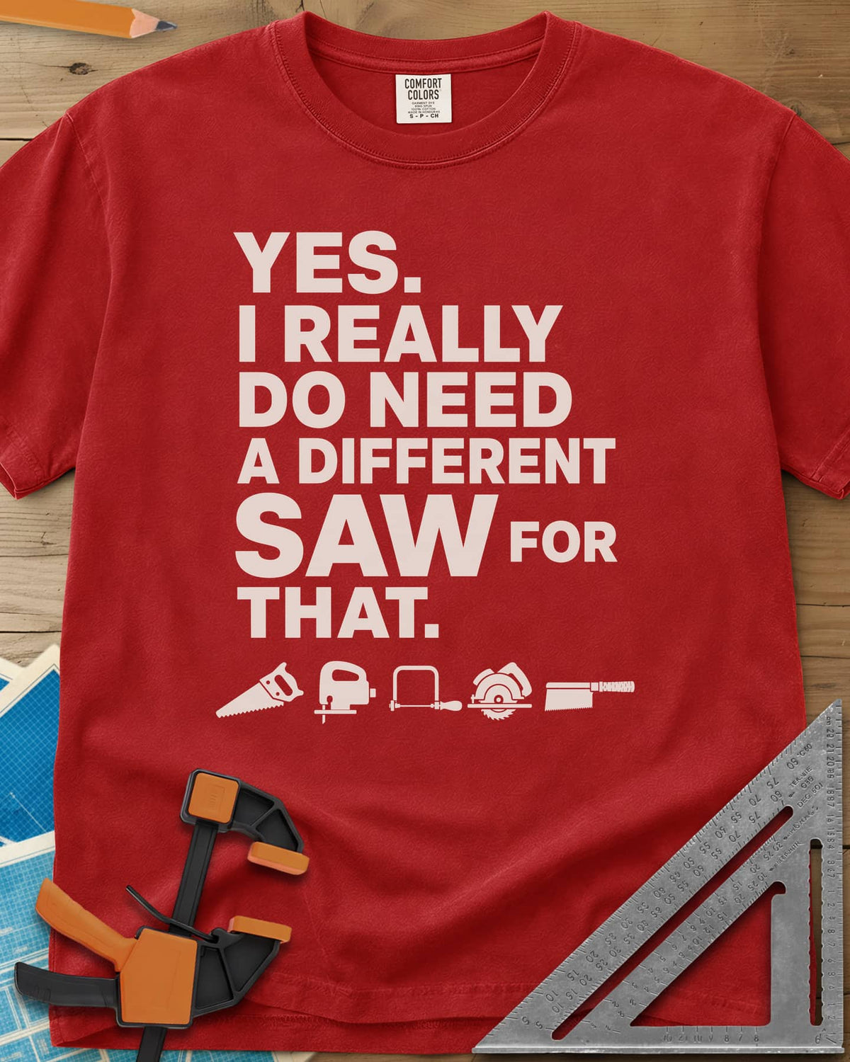 I Really Do Need A Different Saw heavyweight tee in Red, bold stacked lettering above a row of five small saw icons