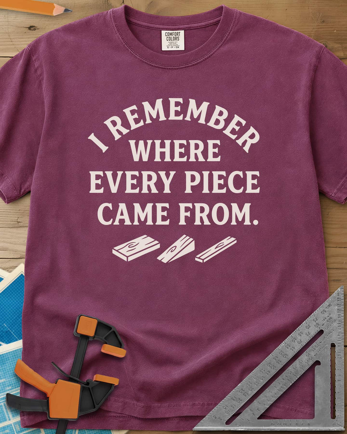 I Remember Where Every Piece Came From heavyweight tee in Berry, arched lettering above three small boards with swirled grain
