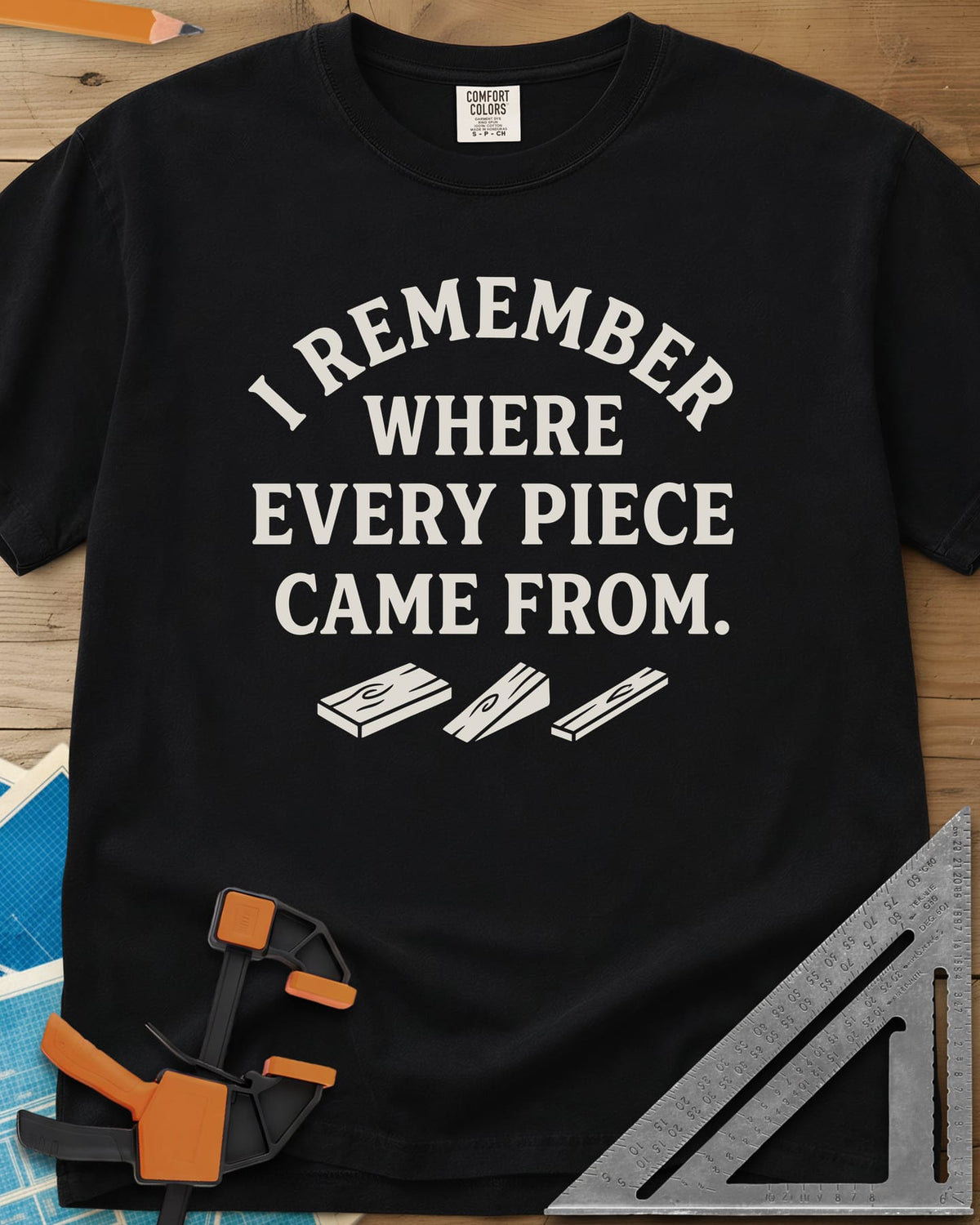 I Remember Where Every Piece Came From heavyweight tee in Black, arched lettering above three small boards with swirled grain