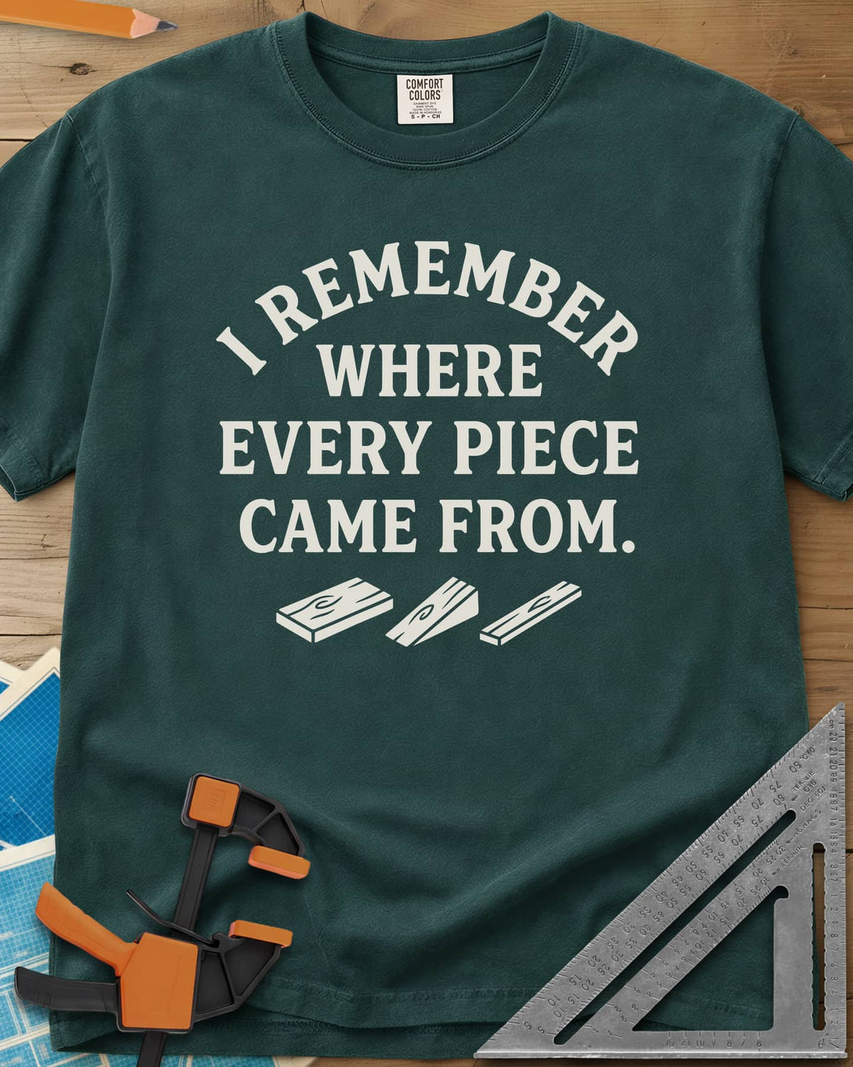 I Remember Where Every Piece Came From heavyweight tee in Blue Spruce, arched lettering above three small boards with