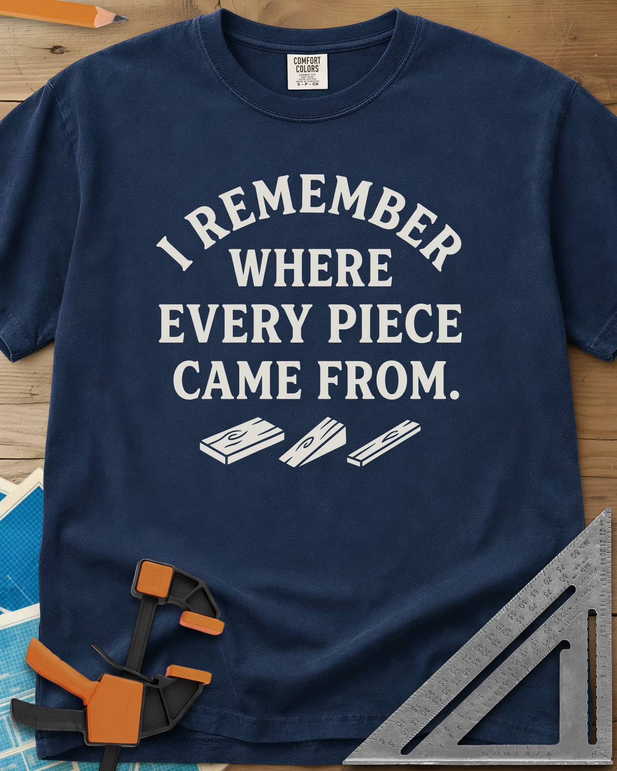 I Remember Where Every Piece Came From heavyweight tee in Navy, arched lettering above three small boards with swirled grain