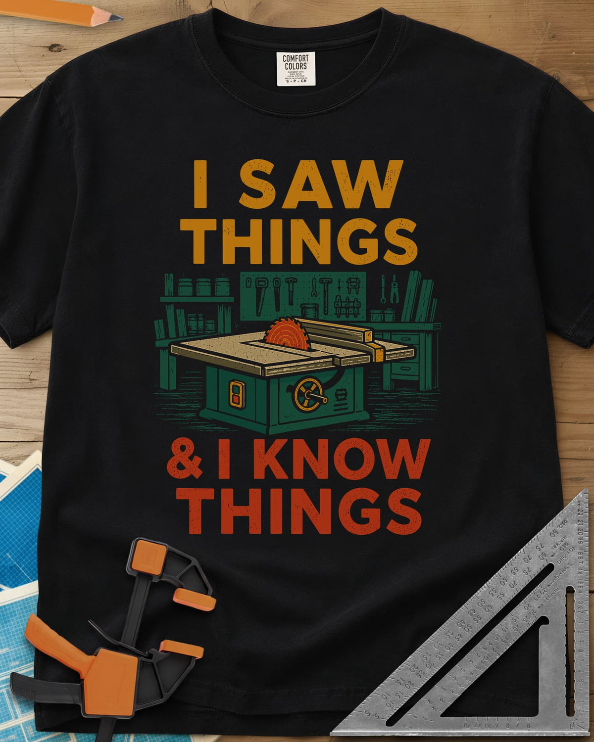 I Saw Things Table Saw Woodworking heavyweight tee in Black, a green table saw in a tidy shop between two lines of lettering