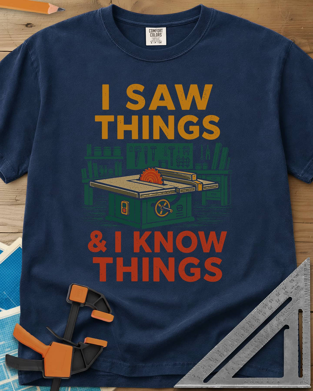 I Saw Things Table Saw Woodworking heavyweight tee in Navy, a green table saw in a tidy shop between two lines of lettering