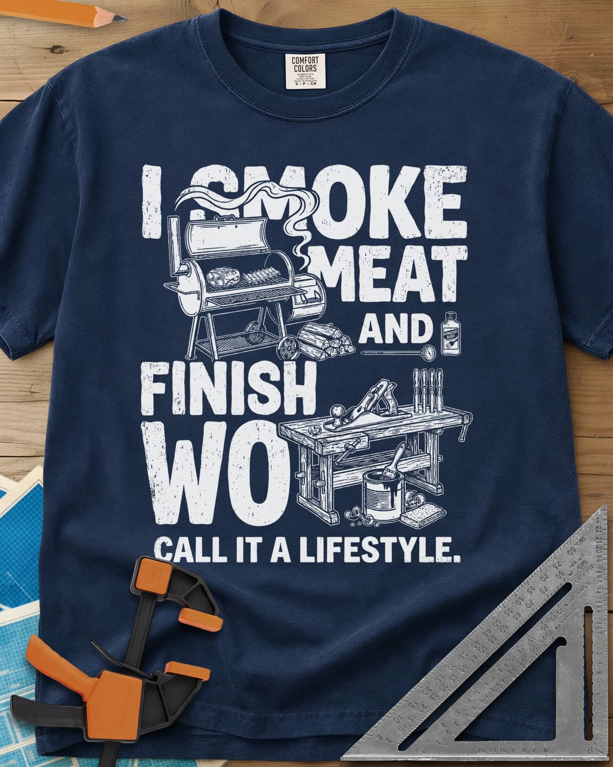 I Smoke Meat And Finish Wood heavyweight tee in Navy, an offset smoker with ribs beside a workbench with a hand plane