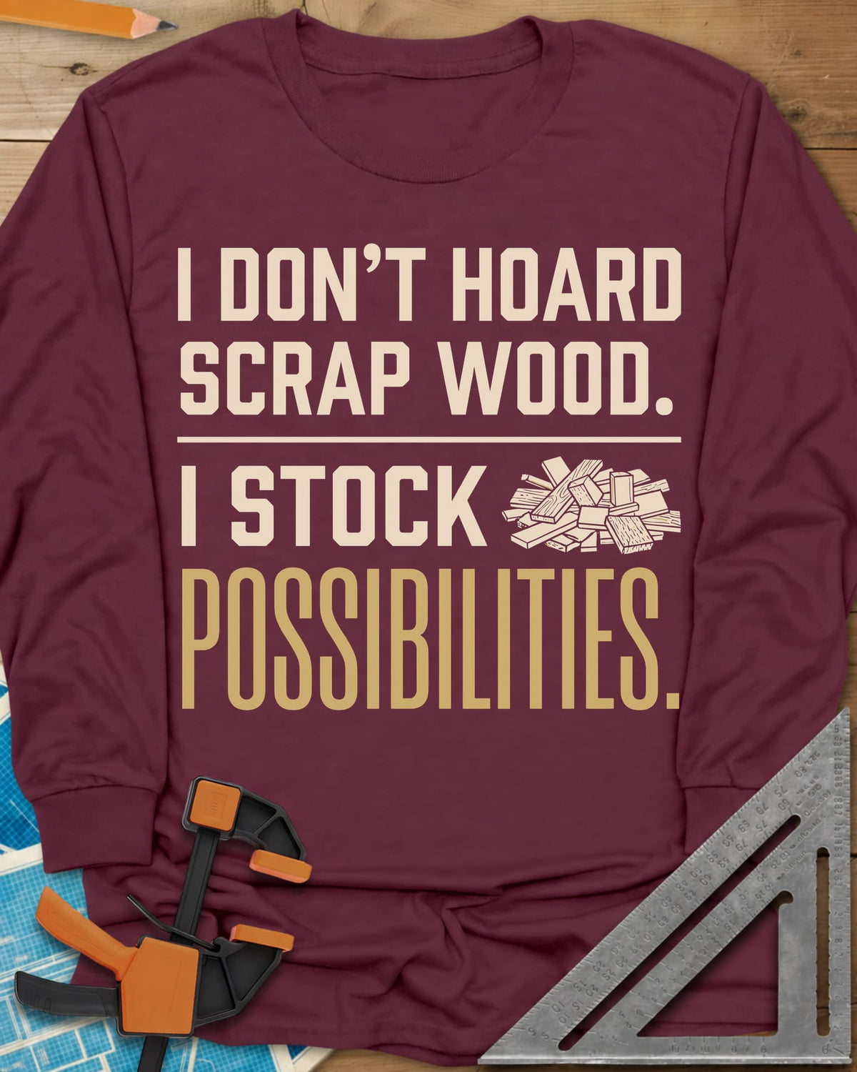 I Stock Possibilities long sleeve shirt in Maroon, bold lettering beside a small pile of scrap wood offcuts