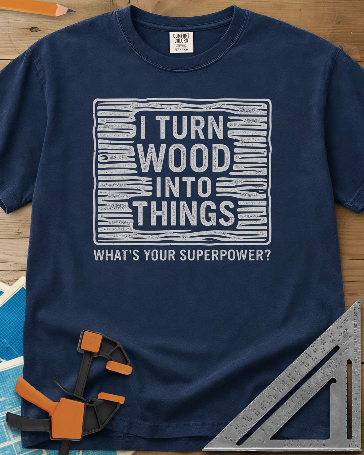 I Turn Wood Into Things heavyweight tee in Navy, stacked block lettering inside a hand-drawn wood-grain frame