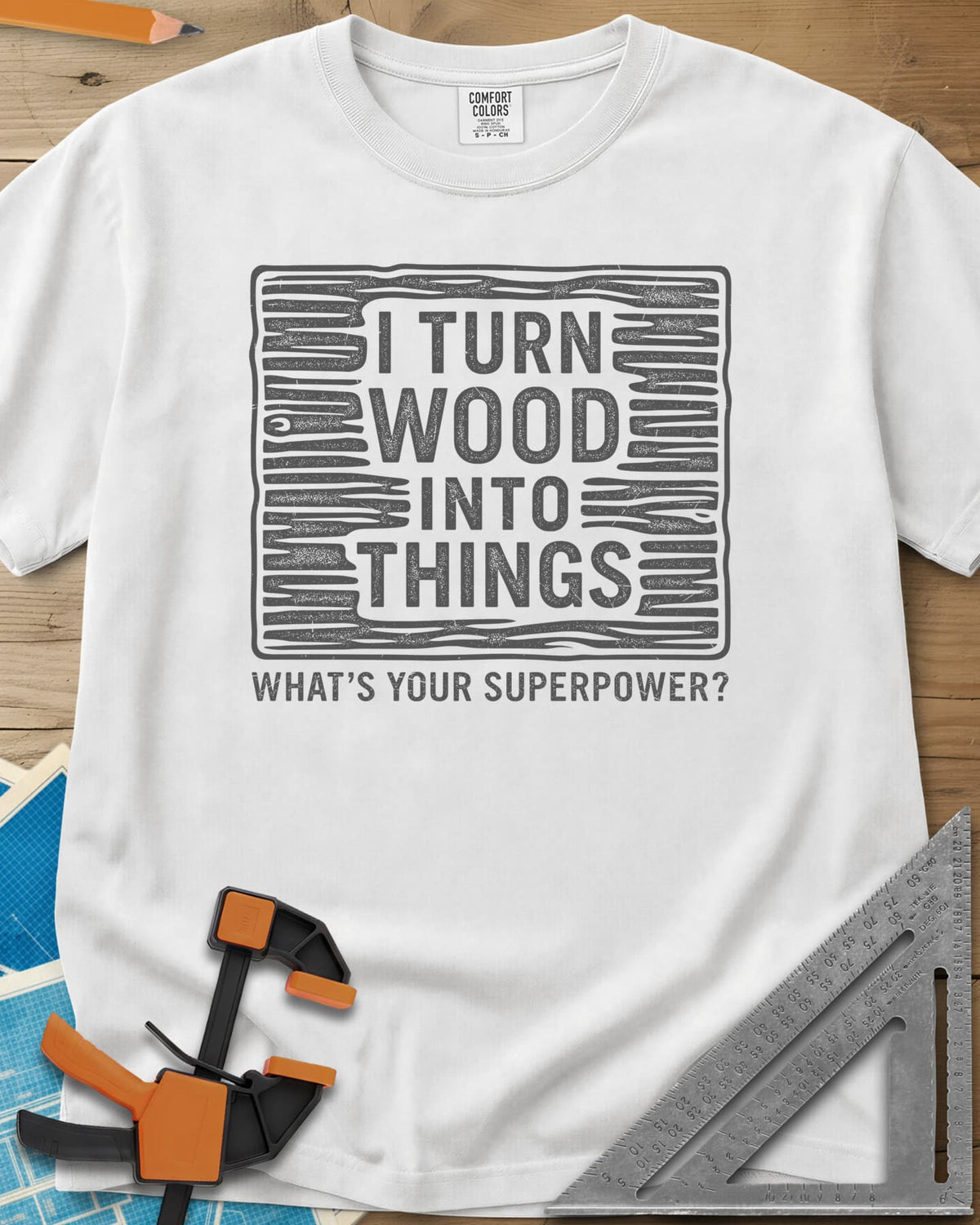 I Turn Wood Into Things heavyweight tee in White, stacked block lettering inside a hand-drawn wood-grain frame