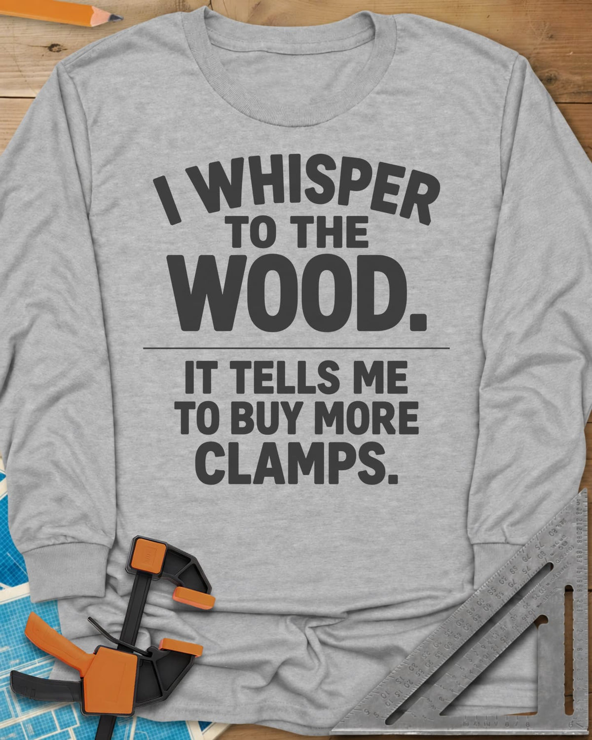 I Whisper To The Wood Clamp Humor long sleeve shirt in Sport Grey, bold stacked lettering split by a thin divider line, no