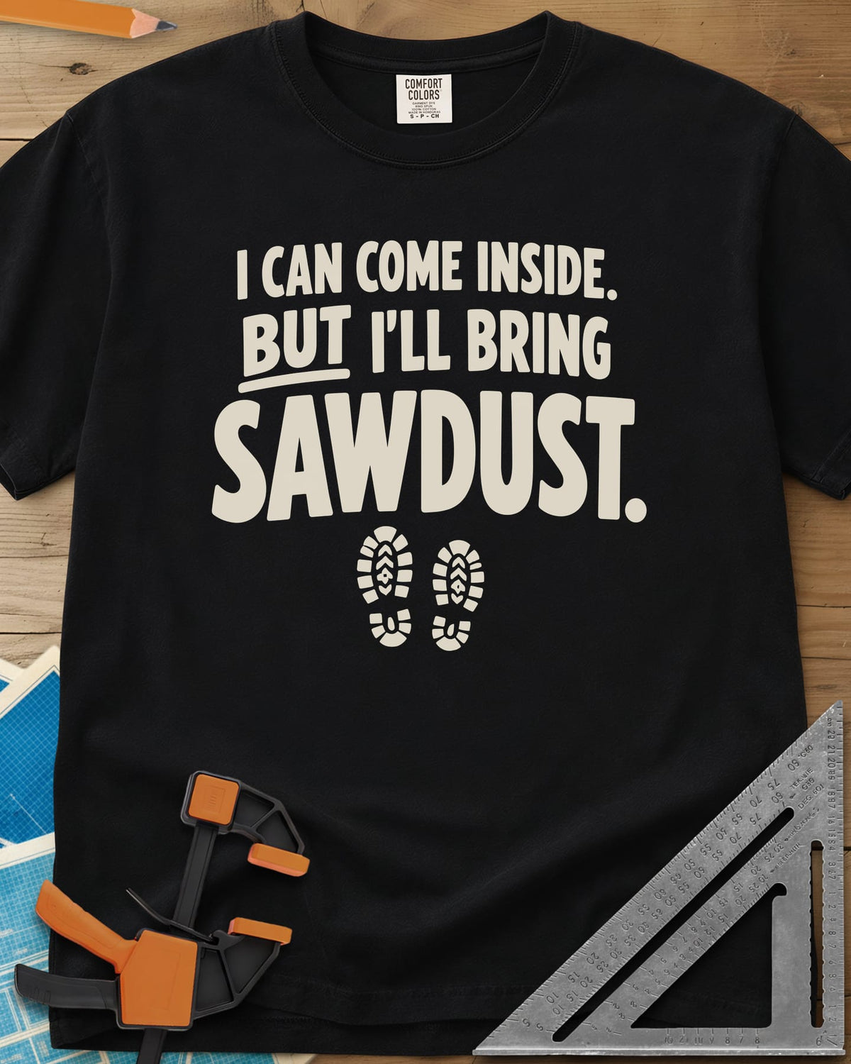 I'll Bring Sawdust heavyweight tee in Black, bold lettering above a pair of boot prints