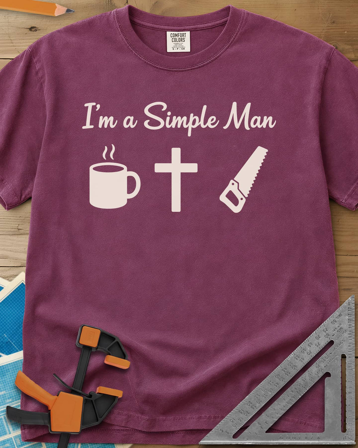 I’m A Simple Man Christian Woodworking heavyweight tee in Berry, script headline above a steaming coffee mug, a cross and a
