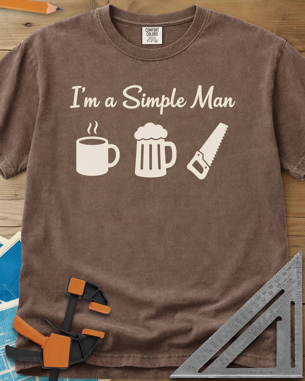 I’m A Simple Man Woodworking heavyweight tee in Espresso, script headline over a steaming coffee mug, a beer mug and a