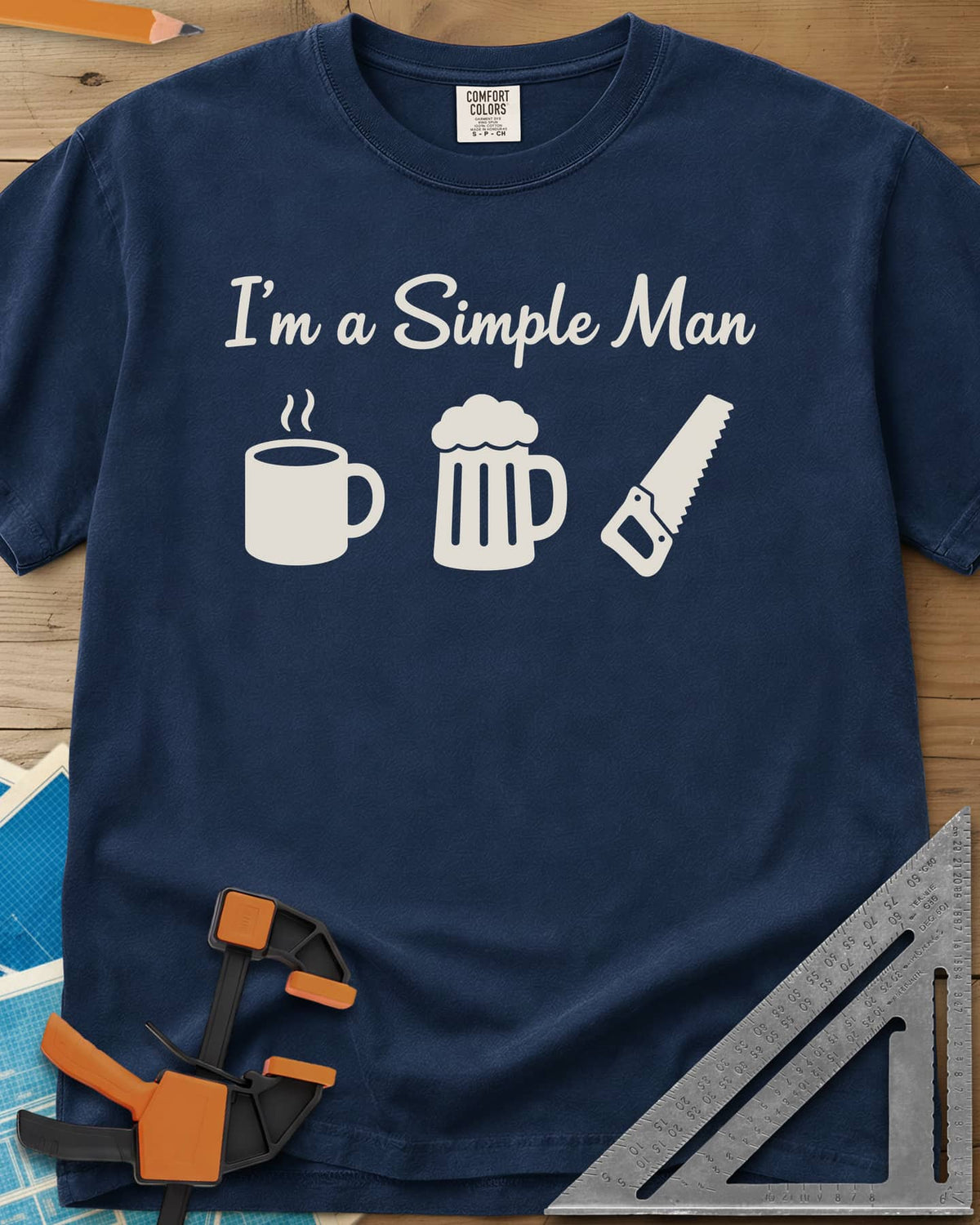 I’m A Simple Man Woodworking heavyweight tee in Navy, script headline over a steaming coffee mug, a beer mug and a handsaw
