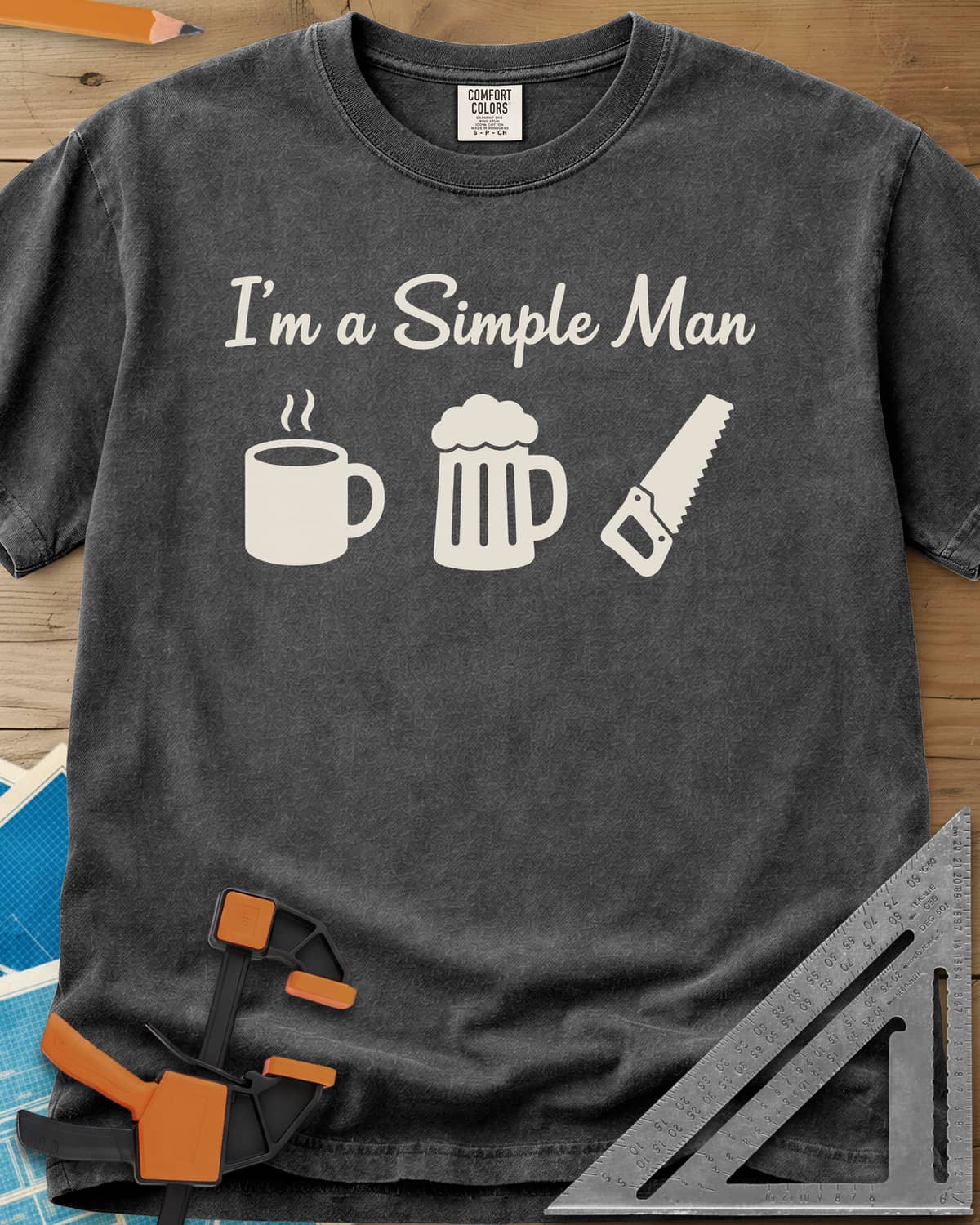 I’m A Simple Man Woodworking heavyweight tee in Pepper, script headline over a steaming coffee mug, a beer mug and a handsaw