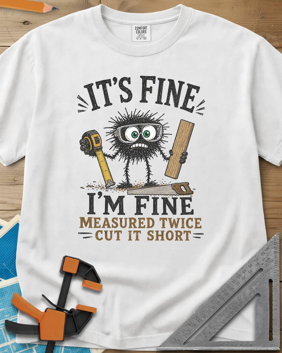 I’m Fine heavyweight tee in White, a fuzzy goggled creature holding a tape measure and a board