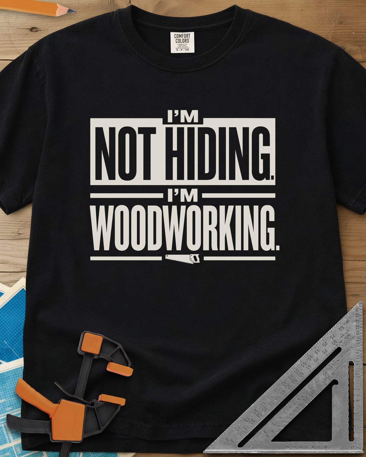 I'm Not Hiding I'm Woodworking heavyweight tee in Black, block lettering with a knocked-out box and a small handsaw