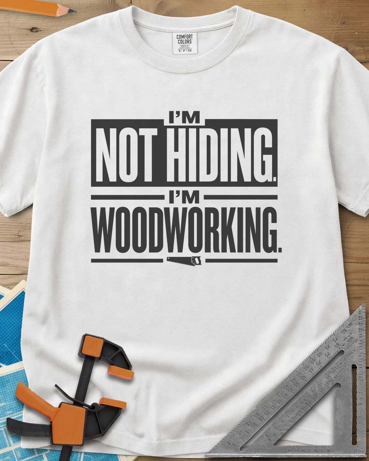 I'm Not Hiding I'm Woodworking heavyweight tee in White, block lettering with a knocked-out box and a small handsaw