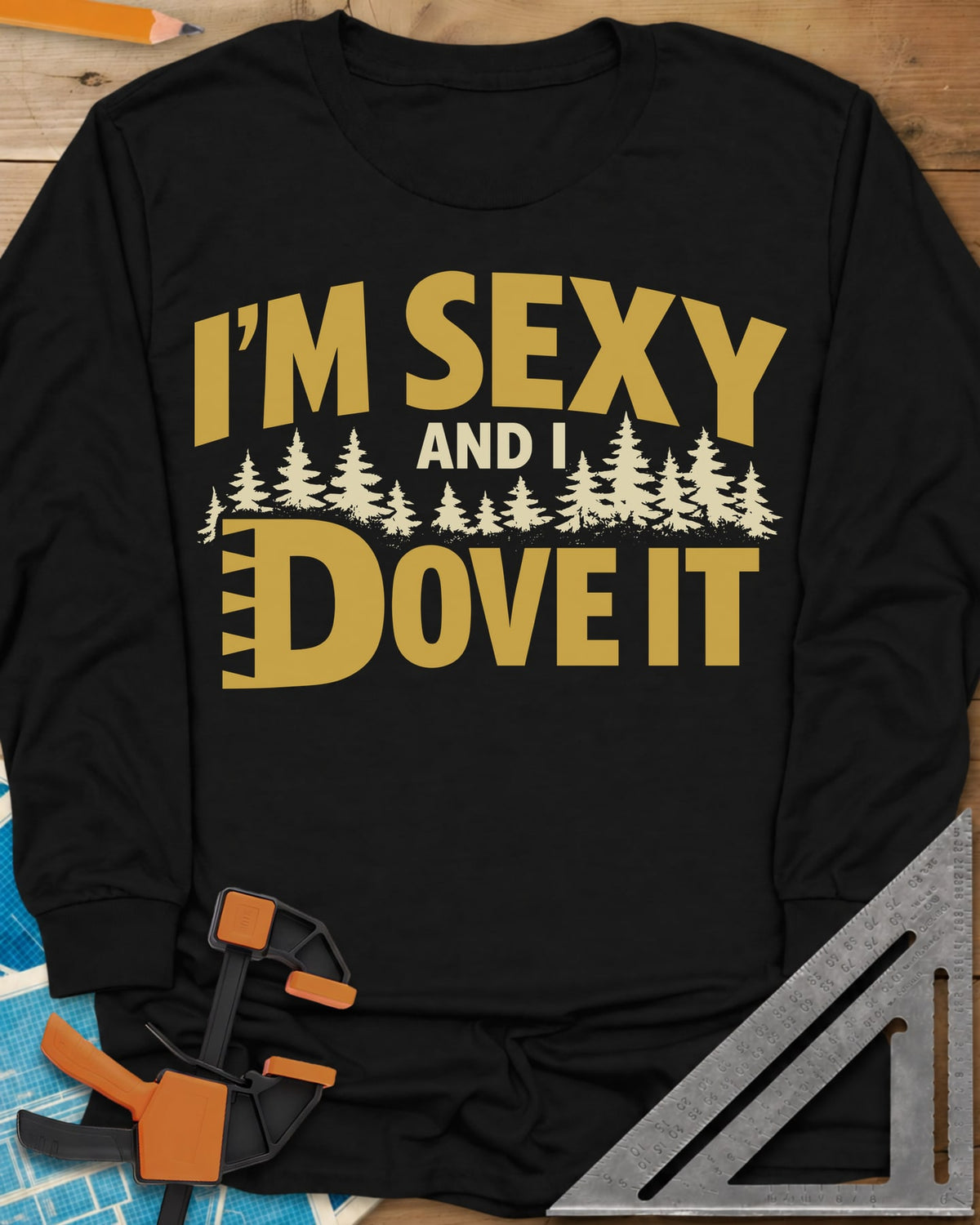 I'm Sexy and I Dove It long sleeve shirt in Black, gold block lettering, a row of pine trees and a notched D