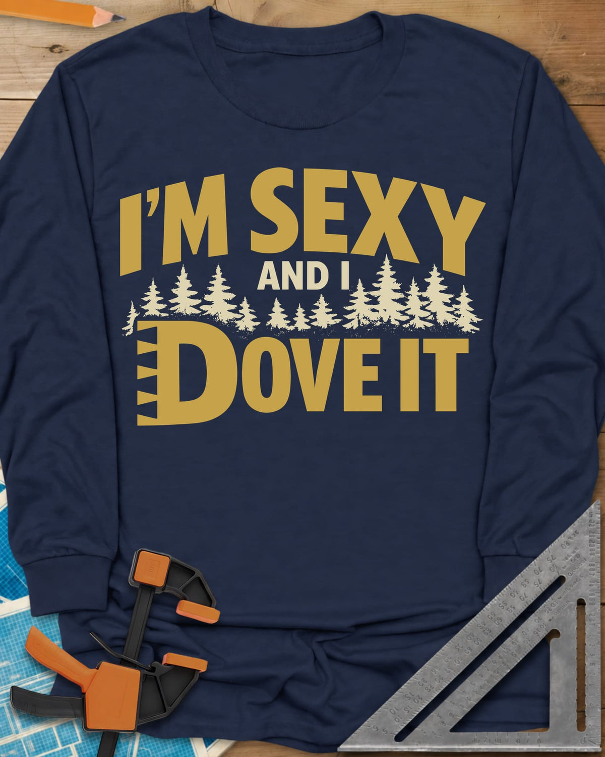 I'm Sexy and I Dove It long sleeve shirt in Navy, gold block lettering, a row of pine trees and a notched D
