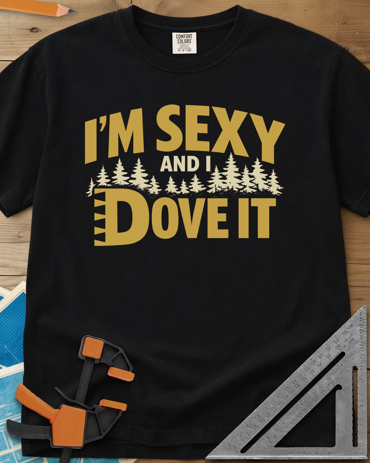 I'm Sexy and I Dove It heavyweight tee in Black, gold block lettering, a row of pine trees and a notched D