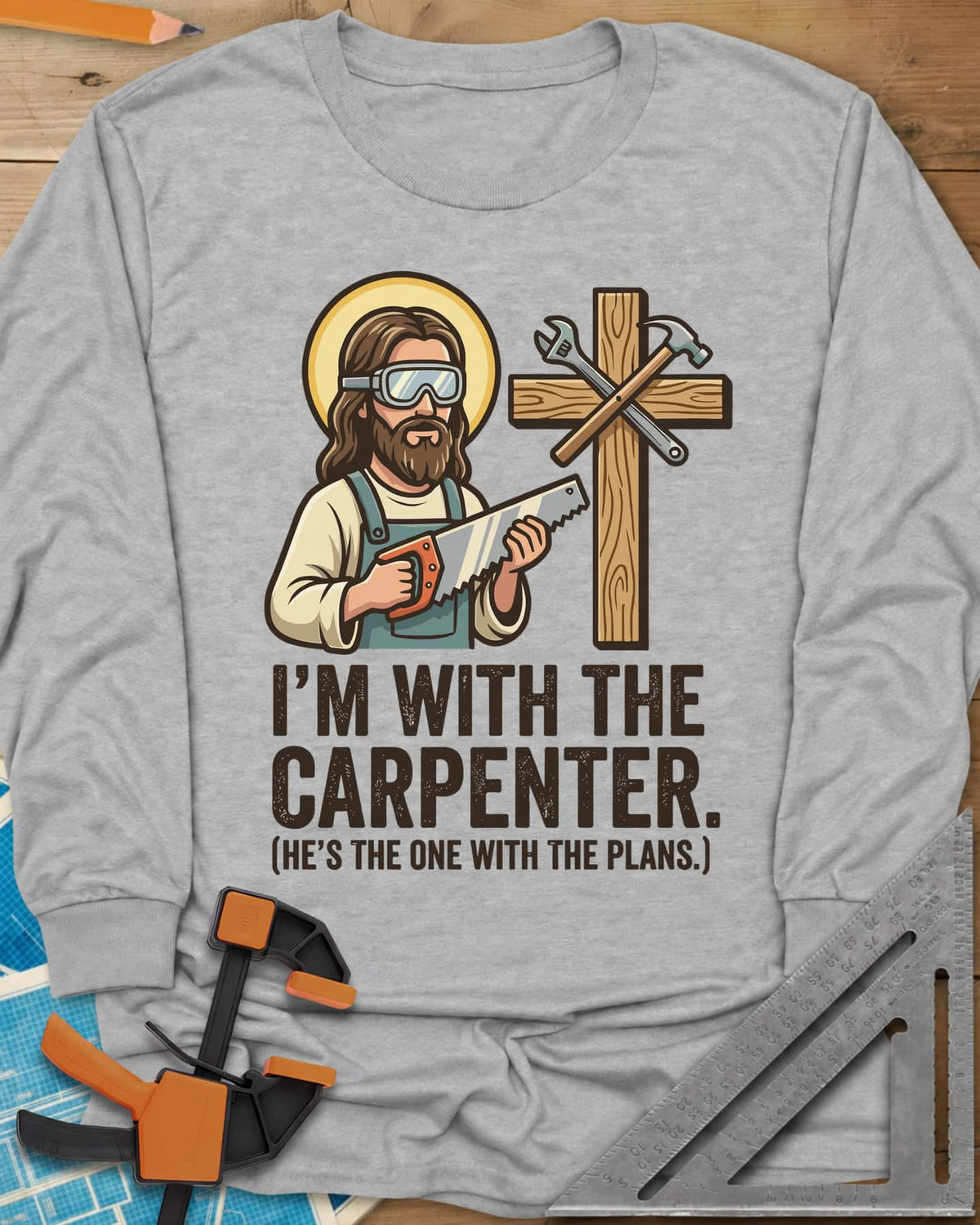 I'm With The Carpenter long sleeve shirt in Sport Grey, haloed cartoon carpenter with a handsaw beside a cross and tools