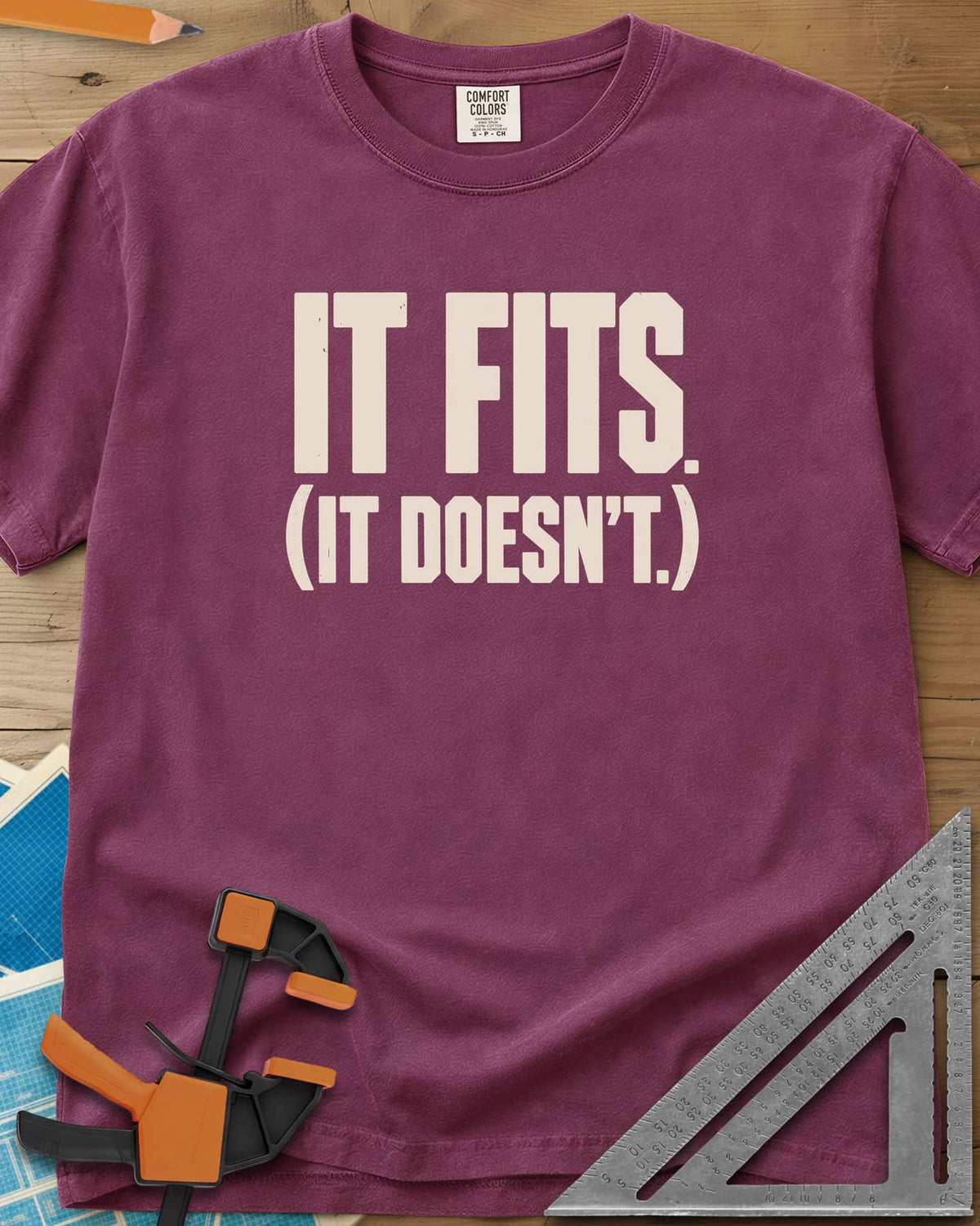 It Fits heavyweight tee in Berry, plain bold block lettering with a bracketed second line