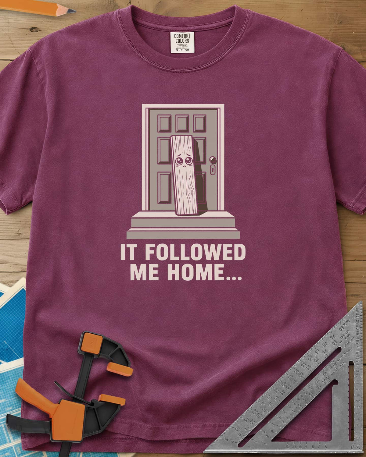 It Followed Me Home Woodworking heavyweight tee in Berry, sad-eyed plank of wood waiting on a doorstep